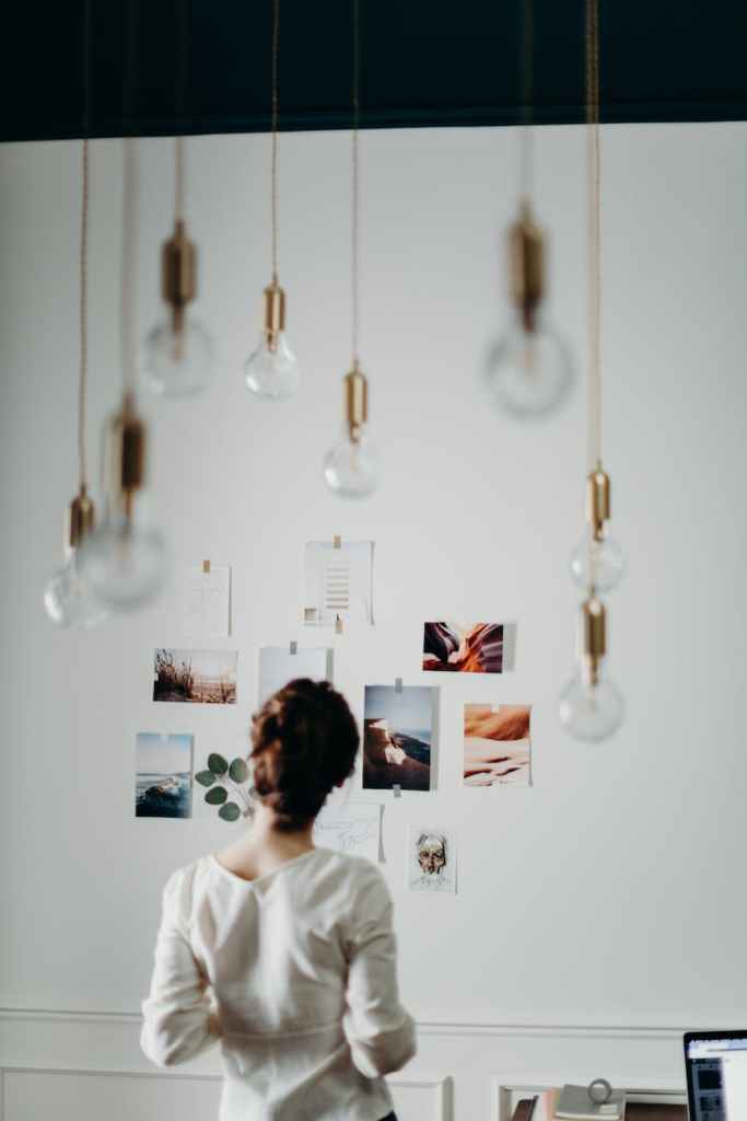 woman wearing white blouse looking on photos