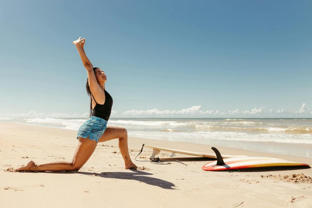young woman stretching before surfing on the beach