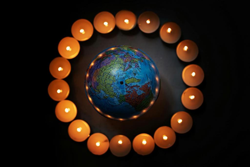 close up shot of a globe and lighted candles
